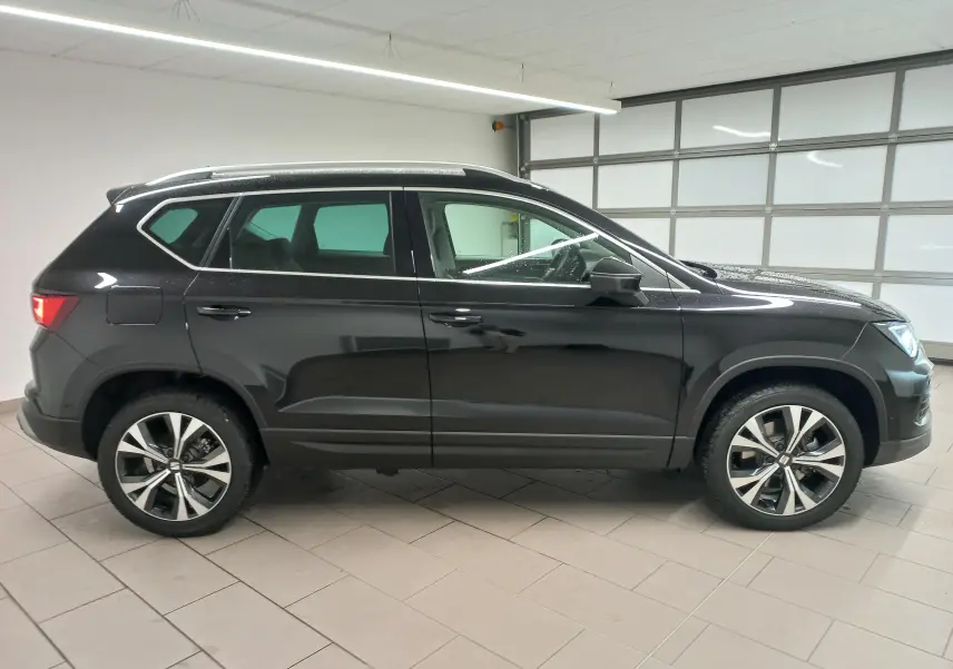 Profil latéral droit d'un SEAT Ateca 2.0 TDI 150 DSG7 Copa noir Magic Nacré avec jantes alliage 18 pouces usinées.