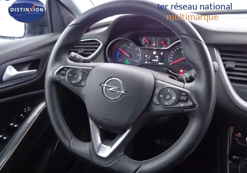 Vue rapprochée du volant en cuir noir de l'Opel Grandland X 1.6 Hybrid Turbo 2021 avec tableau de bord numérique.