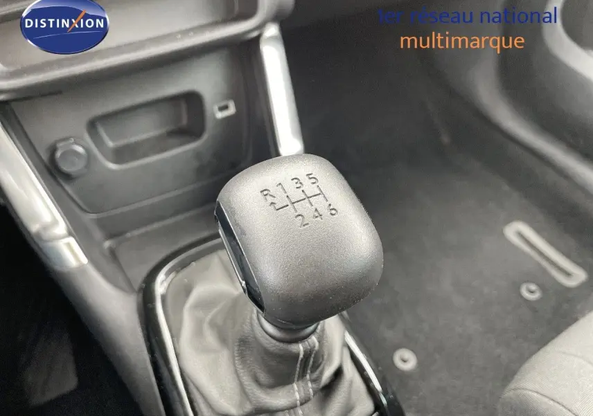 Le levier de vitesses manuel 6 rapports en gros plan dans l'habitacle d'une Citroën C3 Aircross blanc polaire.