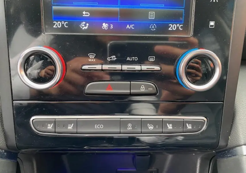 Gros plan sur la console centrale du Renault Koleos 2019, montrant les commandes de climatisation et sièges chauffants.