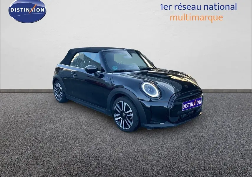 Vue 3/4 avant droite d'une MINI Cabriolet F57 noire Midnight Metal avec capote fermée et jantes bi-ton.