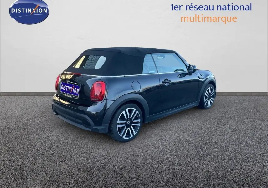 MINI Cabriolet F57 noir Midnight Metal vue 3/4 arrière droit avec capote noire fermée sur sol goudronné.