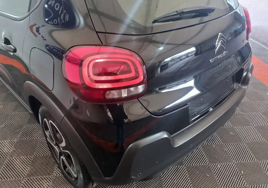 Vue 3/4 arrière droite d'une Citroën C3 noire 2024 avec feux arrière LED distinctifs et jantes stylisées.