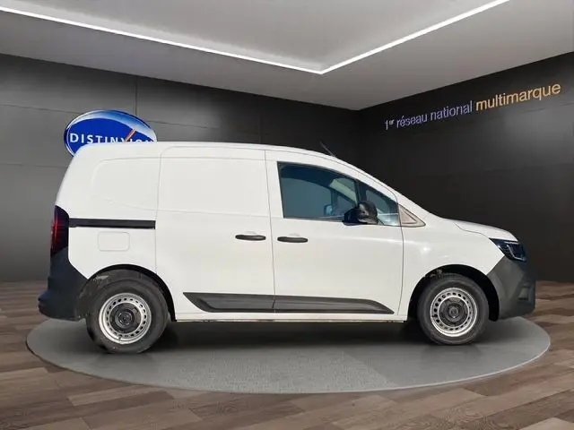 Vue latérale droite d’un Renault Kangoo Van blanc 2023 avec kit bois complet, en intérieur sur plateforme rotative.
