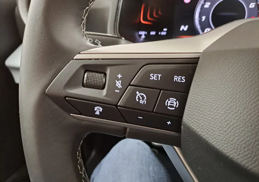 Gros plan sur les commandes du régulateur adaptatif et assistance à la conduite au volant d'une SEAT Ibiza 2025.