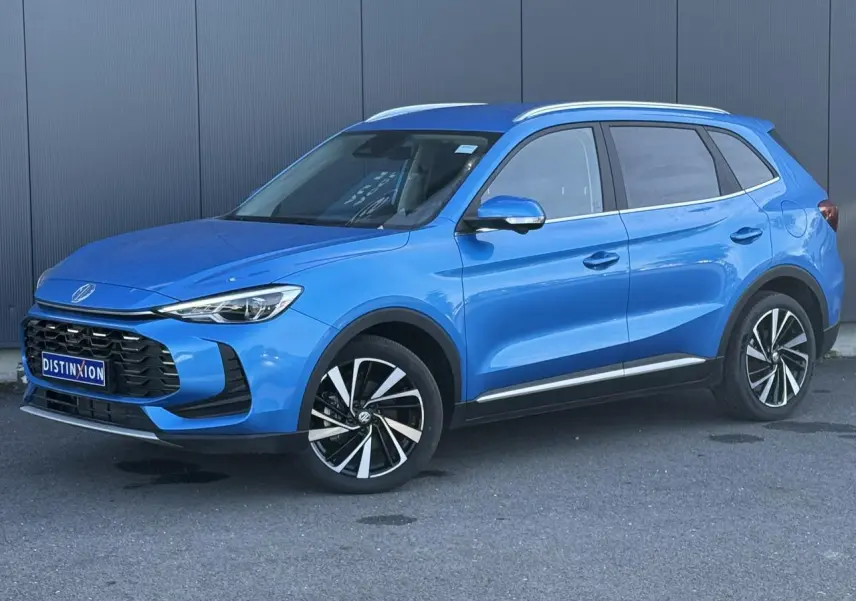 MG Motor ZS 1.5 Hybrid+ 197 Luxury bleu Como en 3/4 avant droit avec jantes alliage et rails de toit visibles.