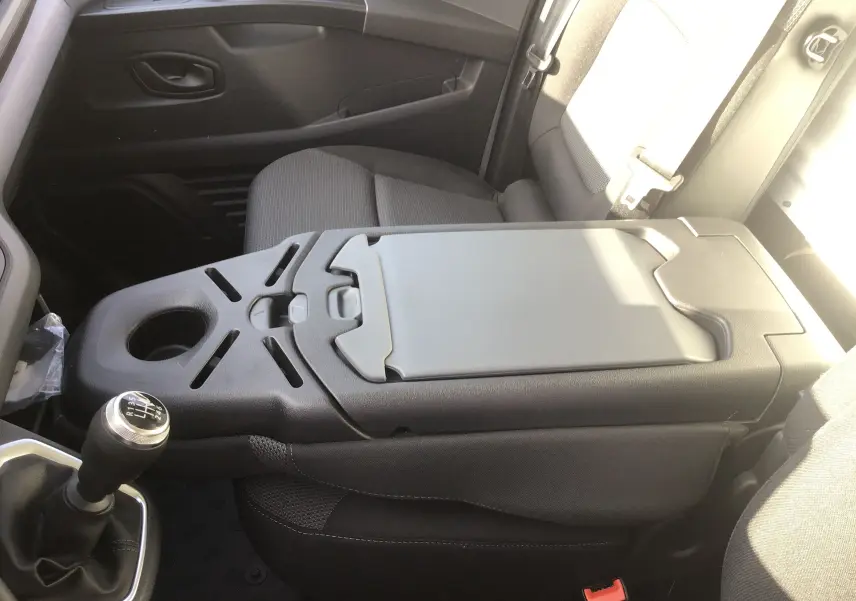 Vue intérieure côté droit du Renault Trafic Fourgon blanc 2025, mettant en valeur la console centrale avec boîte manuelle.