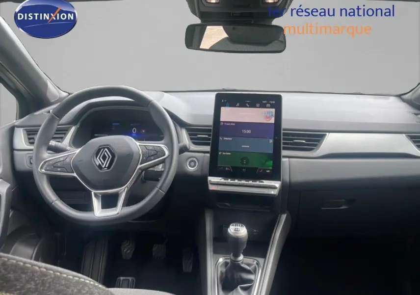 Vue intérieure avant du Renault Captur 2025, tableau de bord avec écran tactile vertical et volant multifonction noir.