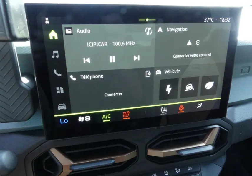 Écran tactile 10 pouces du tableau de bord du Dacia Duster 1.6 Hybrid 2025 avec aérateurs brun cuivré.