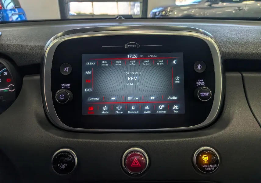 Vue rapprochée de l’écran tactile central de la FIAT 500X 2024, affichant la radio FM sur fond noir.