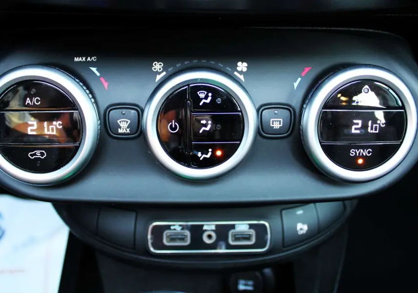 Gros plan sur les commandes de climatisation digitale de la FIAT 500X 2019, avec affichage à 21°C et boutons ronds noirs.