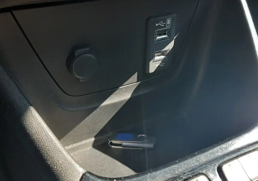 Prise 12V et double port USB en gros plan dans le compartiment central d'un Opel Crossland X 130ch Innovation 2019.