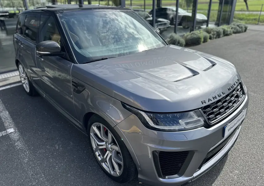 Vue 3/4 avant gauche d'un Range Rover Sport SVR Carbon Edition gris foncé avec jantes alliage et détails carbone sur les rétroviseurs.