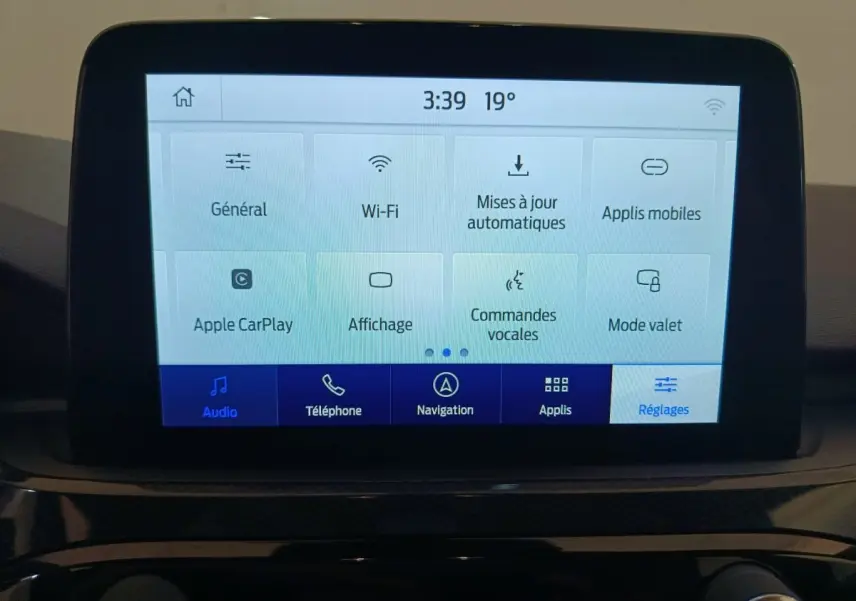 Écran tactile central du Ford Kuga 2024 affichant les réglages Wi-Fi, Apple CarPlay et commandes vocales.