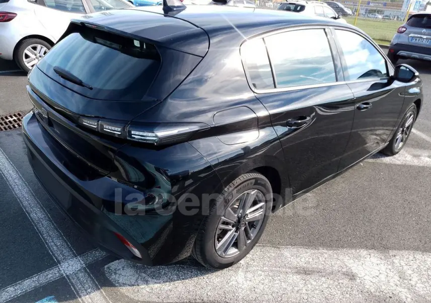 PEUGEOT 308 noir vue 3/4 arrière droit, avec feux arrière LED distinctifs et jantes alliage 16 pouces.