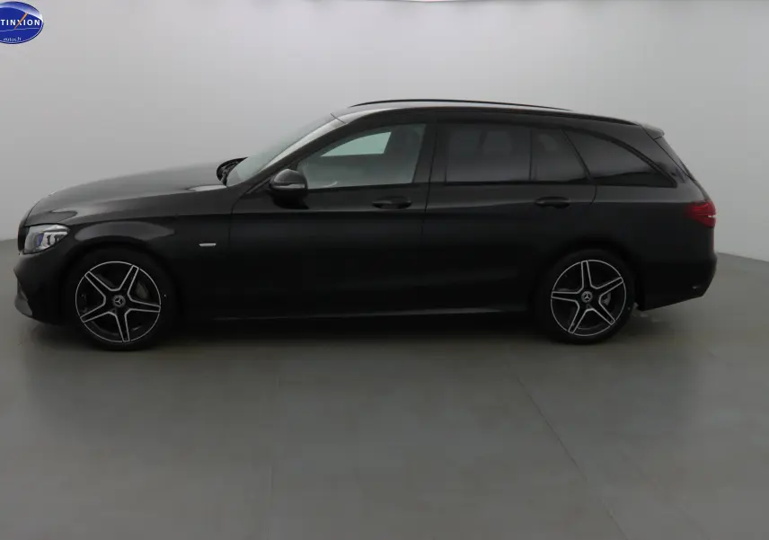 Profil côté gauche d'un break Mercedes Classe C 220D AMG Line noir métal avec jantes alliage 5 branches.