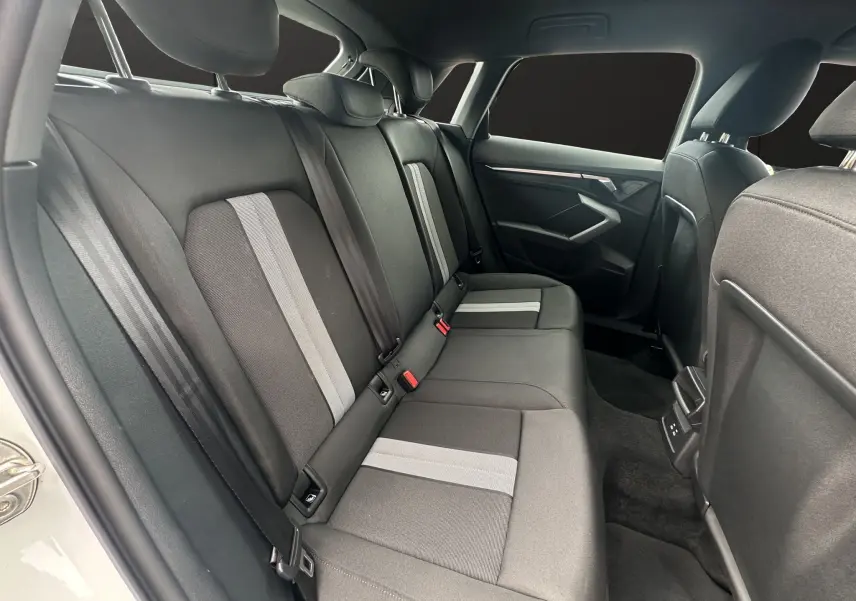 Vue intérieure côté droit des sièges arrière en tissu noir et gris de l'Audi A3 Sportback 2024 finition Advanced Edition.