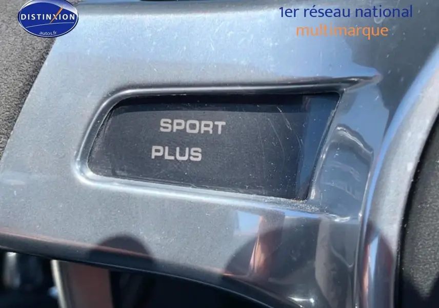 Gros plan sur le bouton "Sport Plus" en finition alu à l'intérieur d'une Porsche Boxster rouge (981) 2015.
