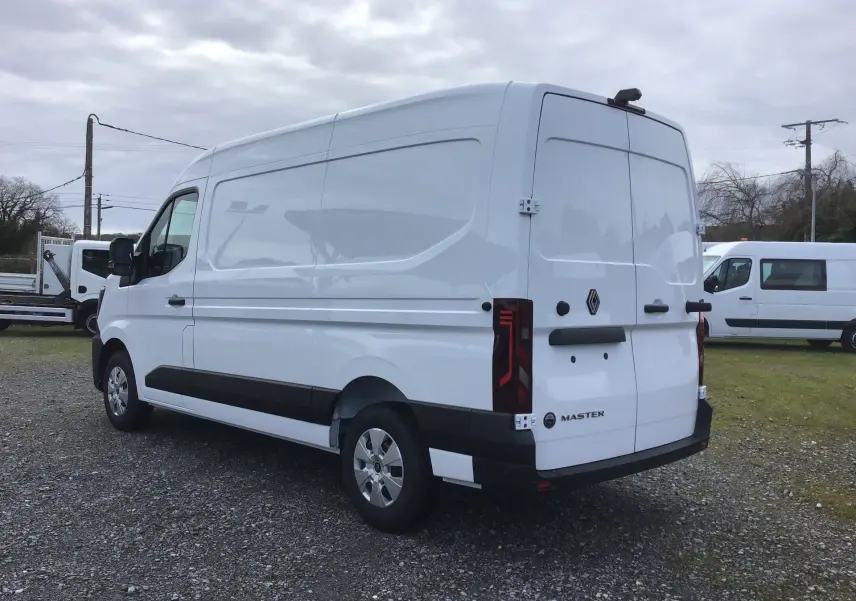 Vue 3/4 arrière droite d’un Renault Master blanc, fourgon utilitaire avec hayon et feux arrière verticaux distinctifs.