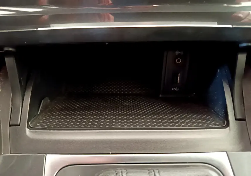 Rangement central noir avec prise USB et jack dans une Volkswagen Golf 1.6 TDI 2019, vue intérieure rapprochée.