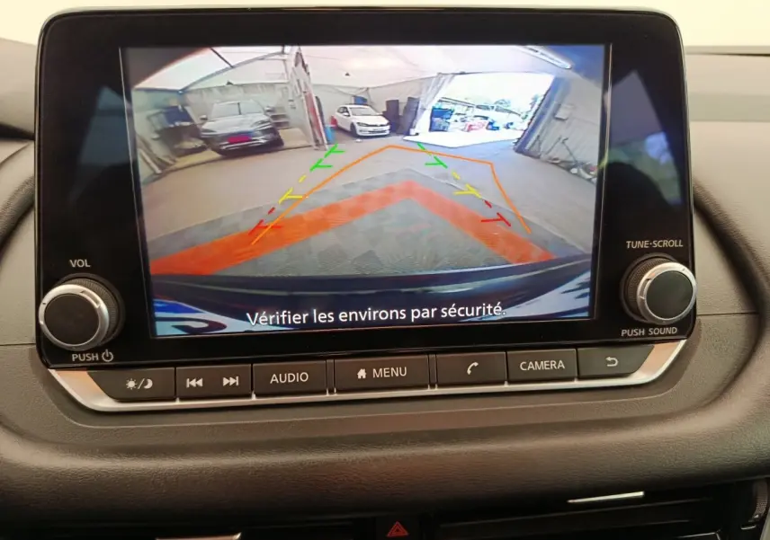 Écran de caméra de recul du Nissan Qashqai e-Power noir, affichant les lignes de guidage colorées en intérieur de garage.