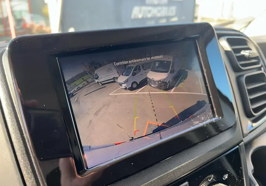 Écran de caméra de recul dans un Fiat Ducato blanc, vue arrière avec marquages de guidage colorés.