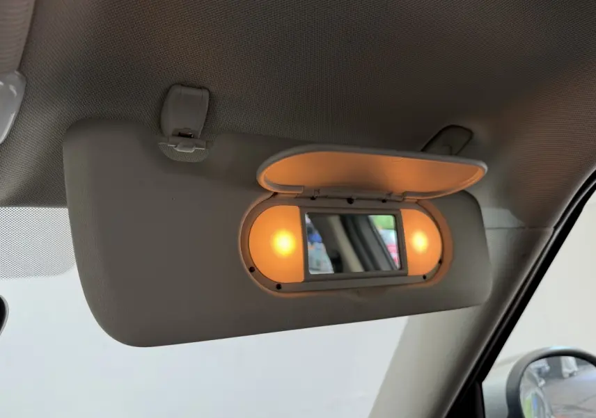 Miroir de courtoisie éclairé sur pare-soleil côté conducteur dans l’habitacle gris clair d’un MINI Countryman 2023.