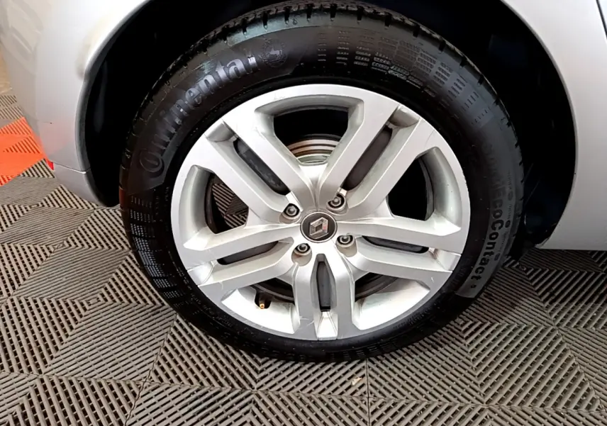 Gros plan sur la roue avant droite gris clair d'une Renault Clio Business TCe 90 avec jante alliage et logo Renault au centre.