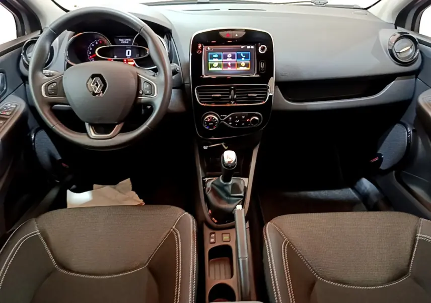 Intérieur de Renault Clio Business TCe 90 2019, vue frontale du tableau de bord avec écran tactile et volant cuir noir.