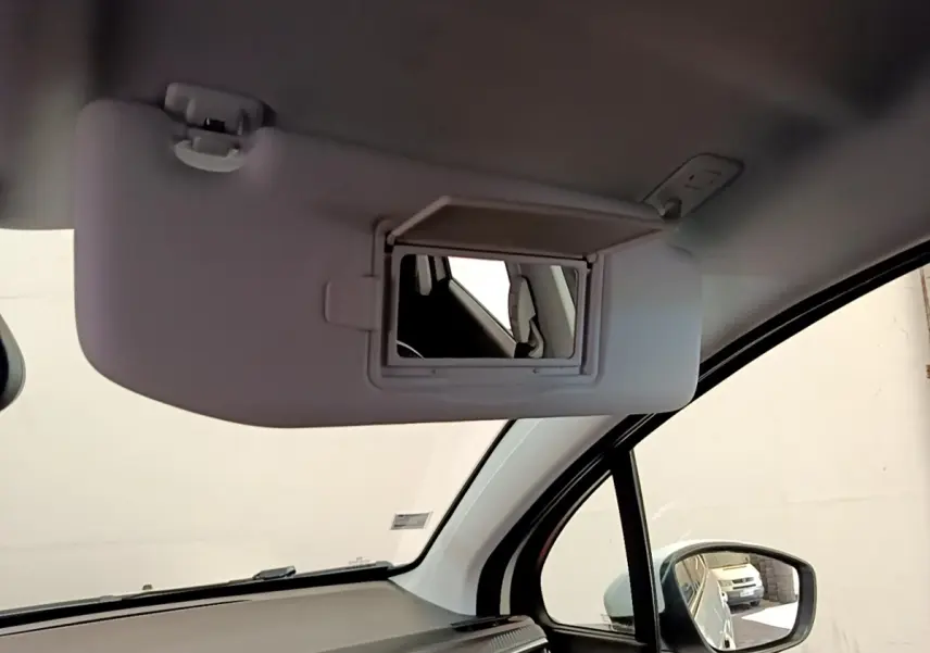 Miroir de courtoisie ouvert sur pare-soleil côté conducteur dans l’habitacle clair d’un Peugeot 2008 2019.