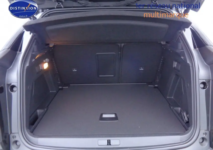 Coffre ouvert du Peugeot 3008 noir perla metal, vue arrière montrant un espace de chargement spacieux et bien éclairé.