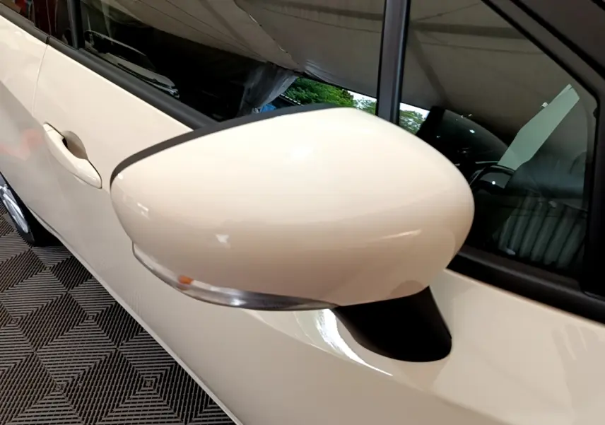 Gros plan sur le rétroviseur côté gauche blanc d'une Nissan Micra IG-T 92 Acenta 2022 essence.