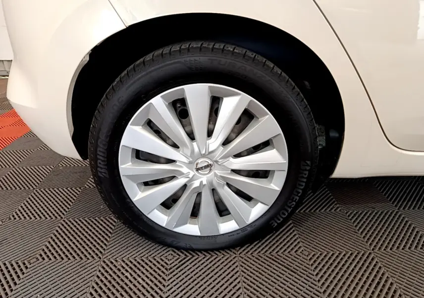 Gros plan sur la roue arrière droite d'une Nissan Micra blanche 2022 avec enjoliveur argenté et pneu Bridgestone.