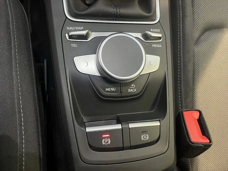 Gros plan sur la molette de commande multimédia et frein à main électronique de l'Audi Q2 30 TFSI S-Line 2021.