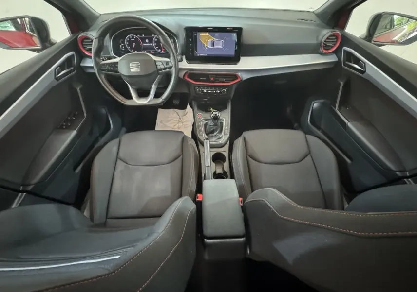 Intérieur noir de la SEAT Ibiza 1.0 TSI 110 FR 2024, vue de dessus sur tableau de bord et sièges avant.