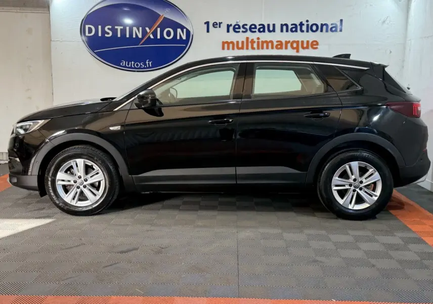 Profil côté gauche d'un Opel Grandland X noir 2021, finition Elegance Business, roues alliage et feux arrière LED.