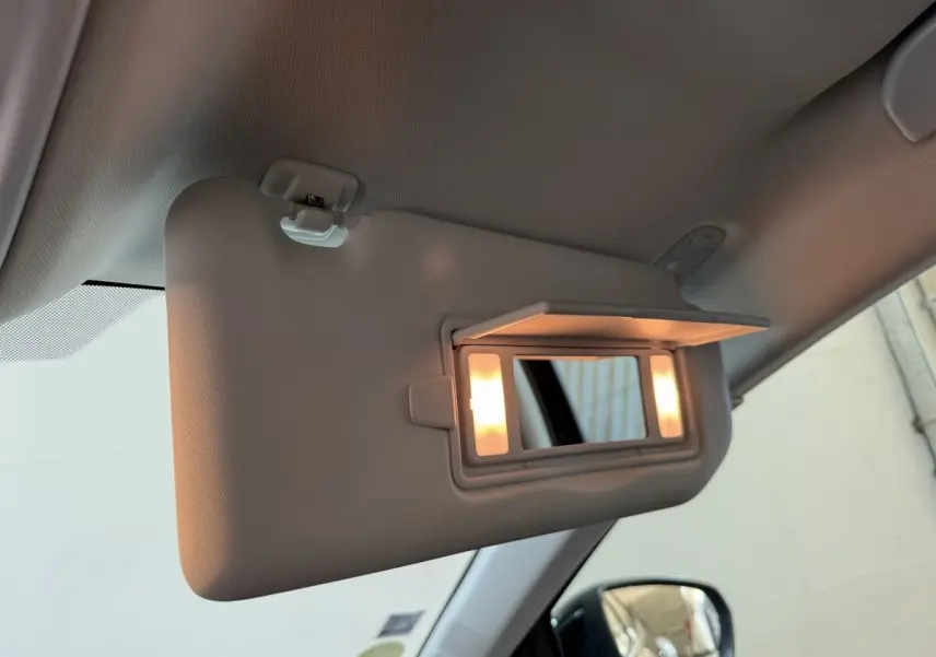 Miroir de courtoisie éclairé sur pare-soleil côté conducteur de l’Opel Grandland X noir, vue intérieure avant gauche.