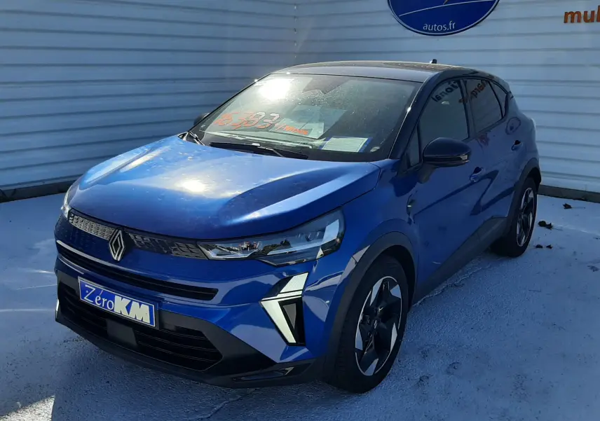 Renault Captur E-Tech Hybrid 145ch Techno bleu iron avec toit noir, vue 3/4 avant droit, jantes alliage et feux LED distinctifs.