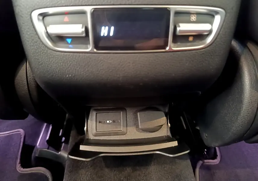 Gros plan sur la commande de climatisation arrière et prise 12V dans l’habitacle du Mercedes GLC 300 e AMG Line blanc.