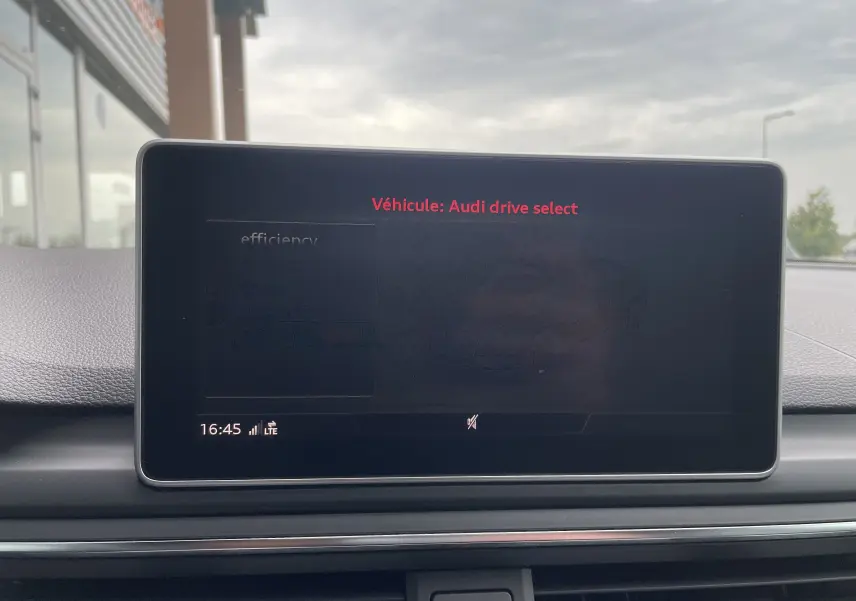 Écran central de l'Audi S4 2016 affichant le menu Audi drive select, intérieur gris sous ciel nuageux.