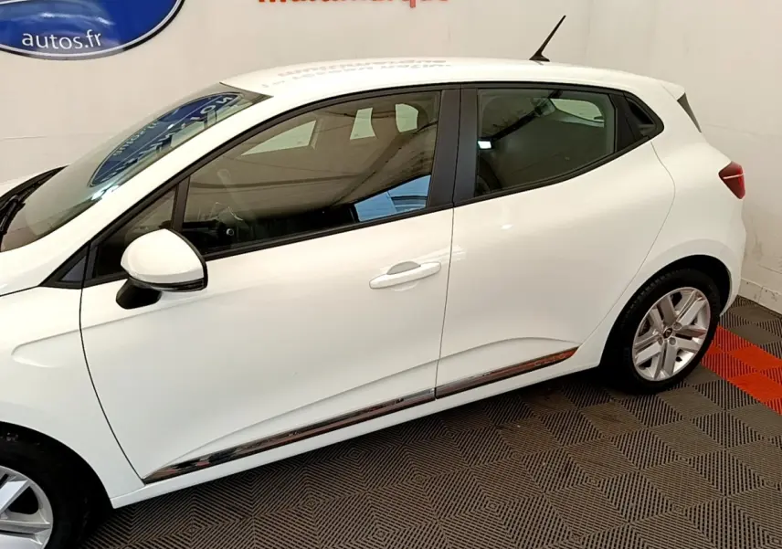 Profil côté gauche d'une Renault Clio Business Blue dCi 85 blanche, avec jantes alliage et rétroviseurs blancs.