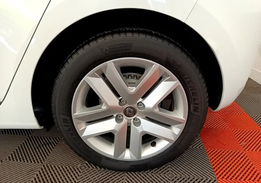 Gros plan sur la roue arrière droite blanche d’une Renault Clio Business Blue dCi 85 avec jante alliage et pneu Michelin.