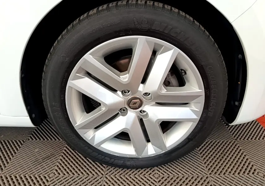 Gros plan sur la roue avant gauche blanche d'une Renault Clio Business Blue dCi 85, jante alliage et pneu Michelin.