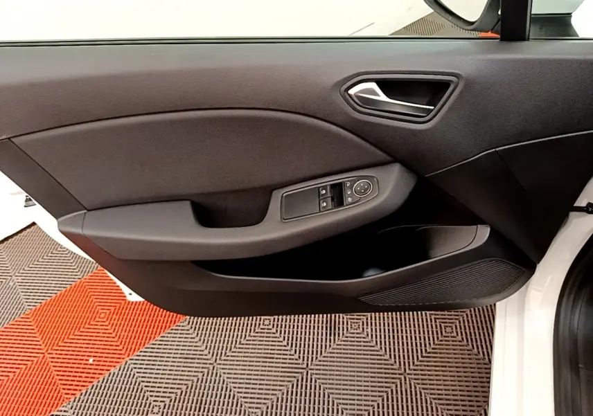 Vue rapprochée de la porte avant gauche blanche de la Renault Clio Business Blue dCi 85 avec commandes électriques.