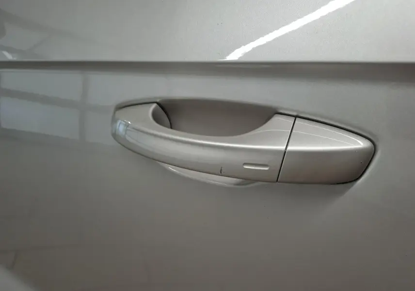 Poignée de porte côté gauche gris ivoire métallisé du Volkswagen T-Roc Cabriolet 1.5 TSI R-Line 2022 avec capote noire.