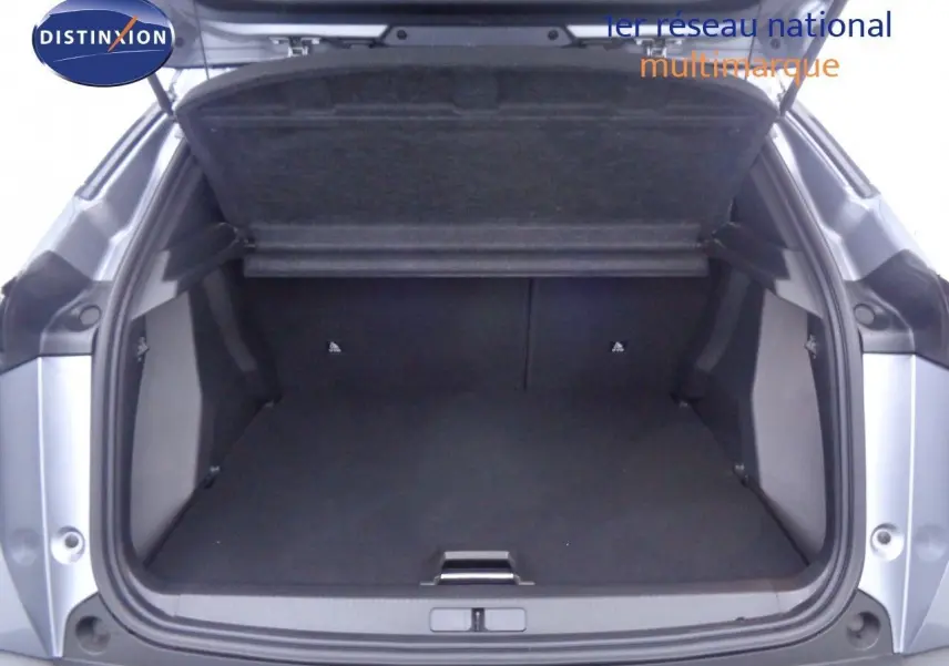 Coffre ouvert en vue arrière d'une Peugeot 2008 gris Artense métal avec toit noir, montrant un espace de chargement vide.
