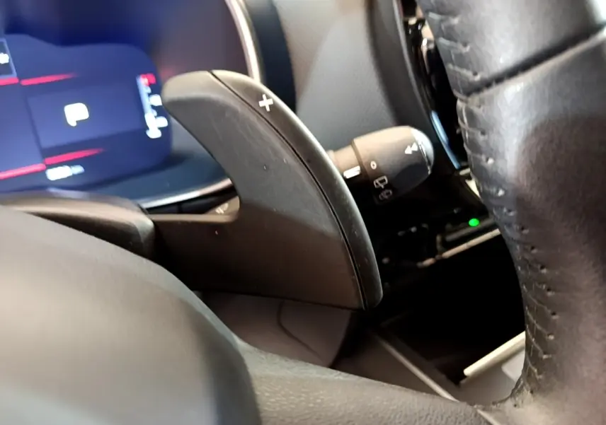 Gros plan sur la palette de changement de vitesse droite noire du volant cuir du Citroën C5 Aircross 2023, intérieur moderne.