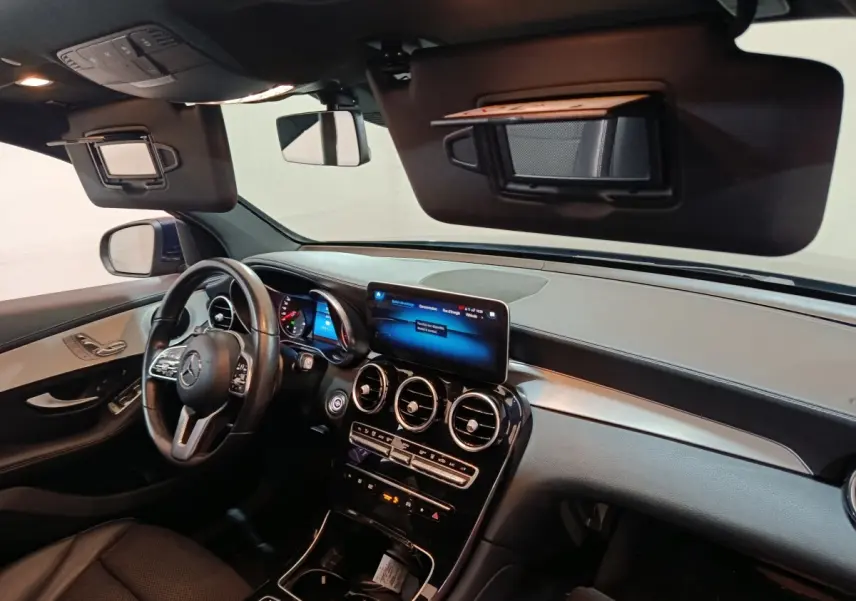 Intérieur avant du Mercedes GLC 300 E Business Line 2021, tableau de bord noir avec écran tactile central et volant cuir.