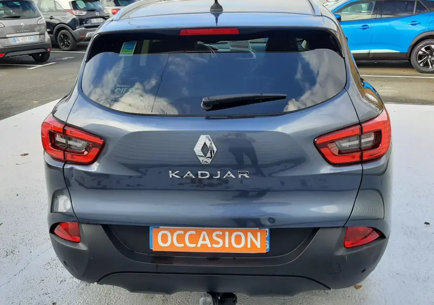 Vue arrière d'un Renault Kadjar gris 2018 avec feux rouges et attelage visible sur un parking.