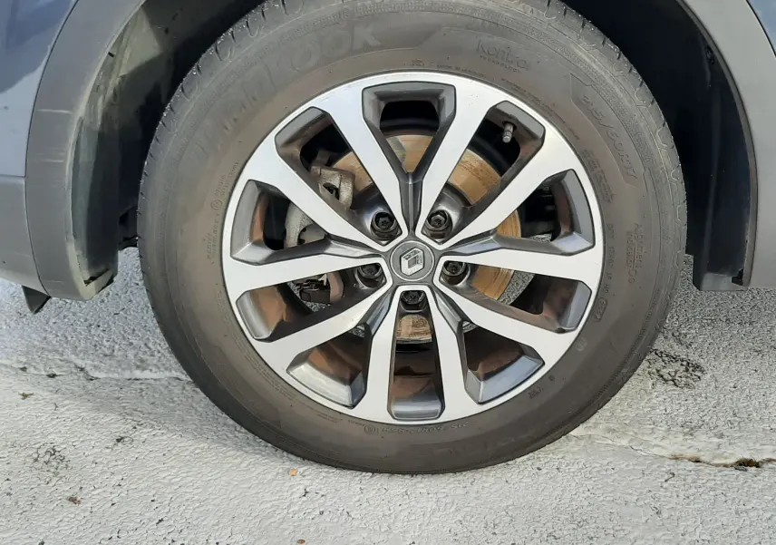 Gros plan sur la roue avant droite du Renault Kadjar gris 2018 avec jante alliage à motifs en étoile.